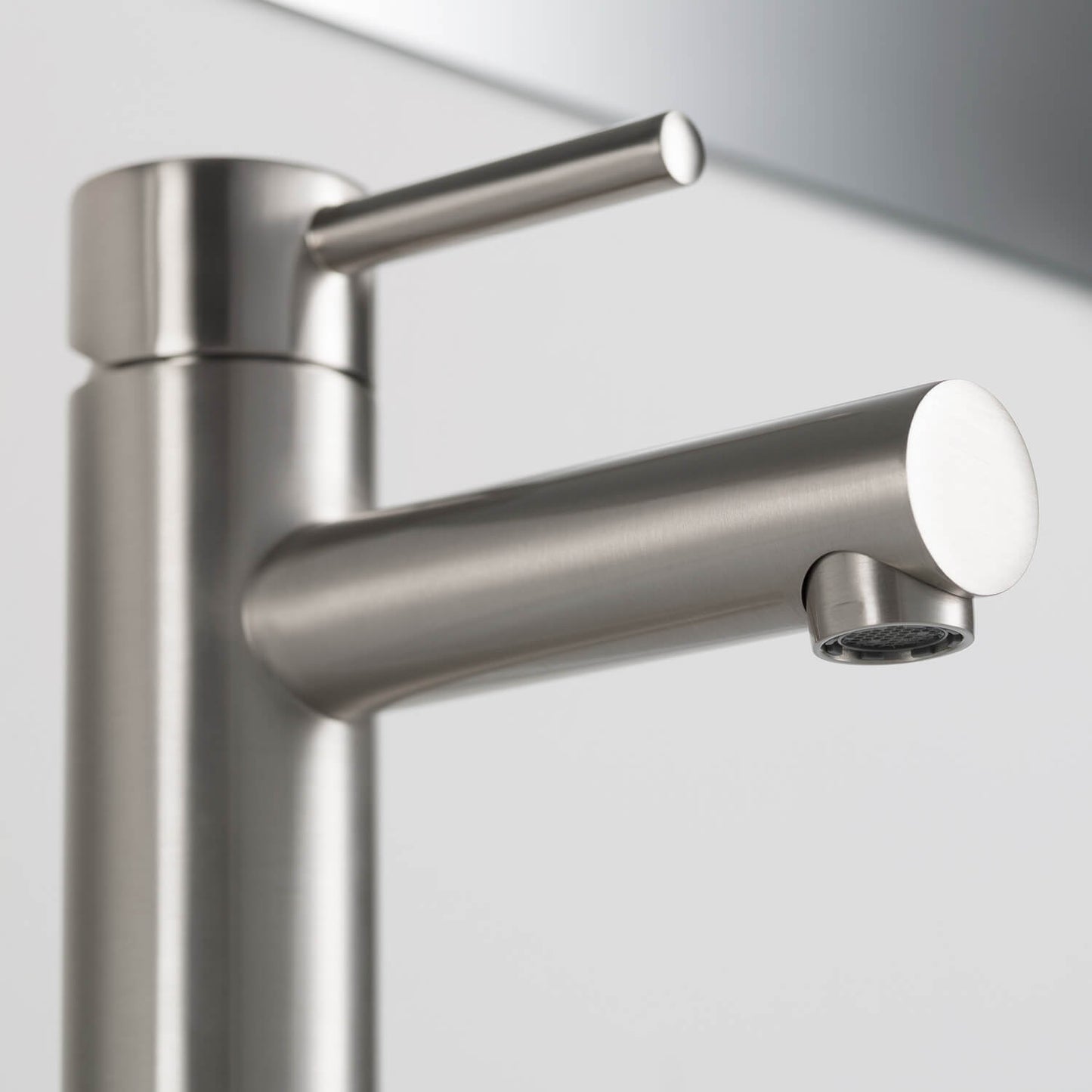 Close-up of Aquavit Circular brushed nickel basin faucet spout and Neoperl aerator