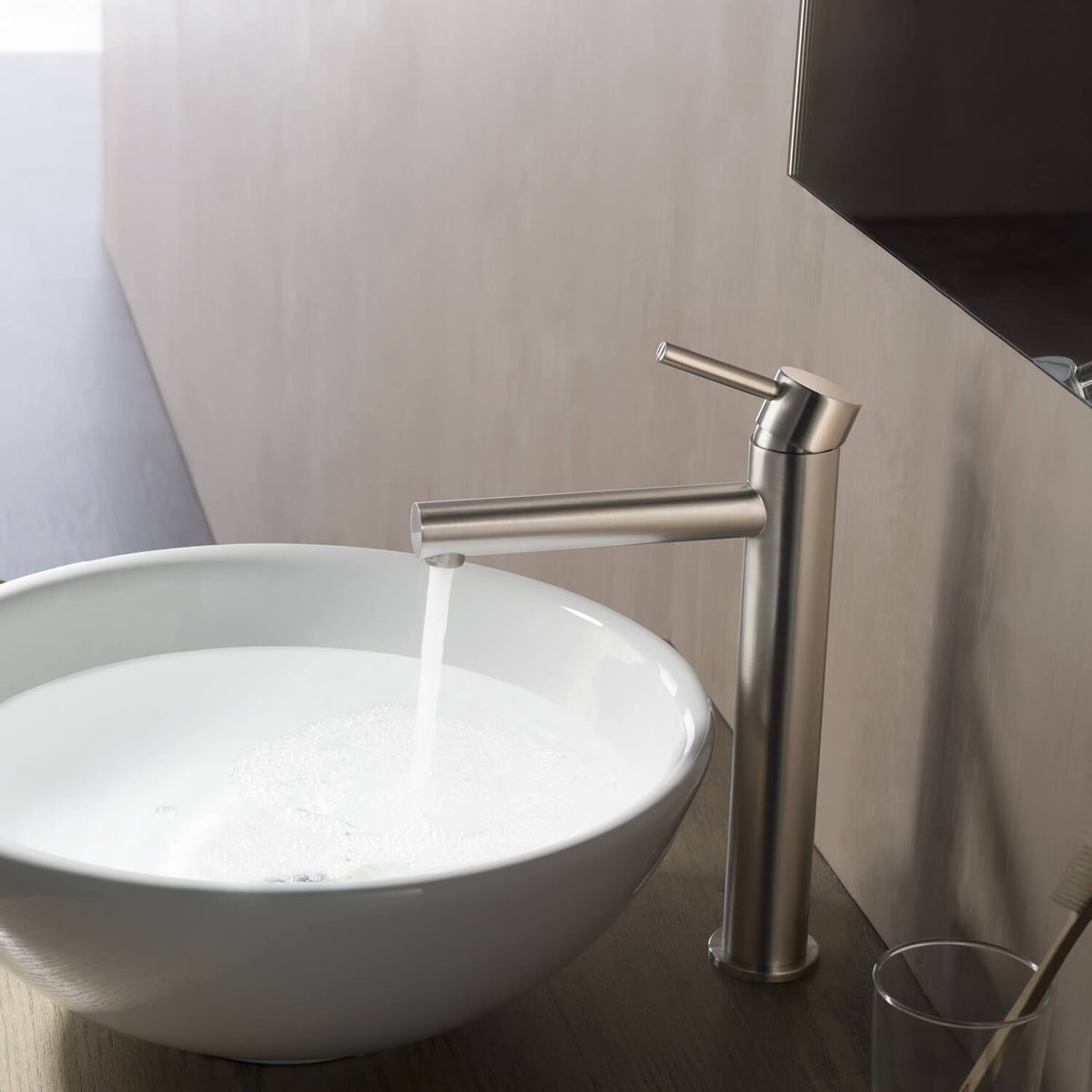 Aquavit Circular AT090212 brushed nickel faucet installed beside a round vessel sink