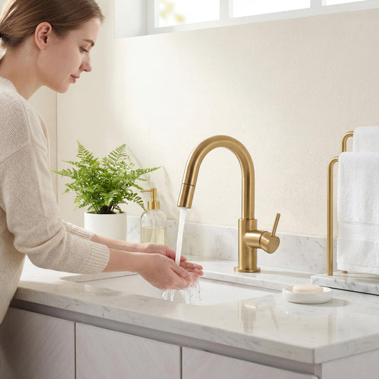 Aquavit Circular brushed brass pull-out basin faucet AT090811 with woman washing hands