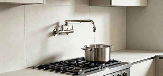 Wall-mounted pot filler above kitchen cooktop