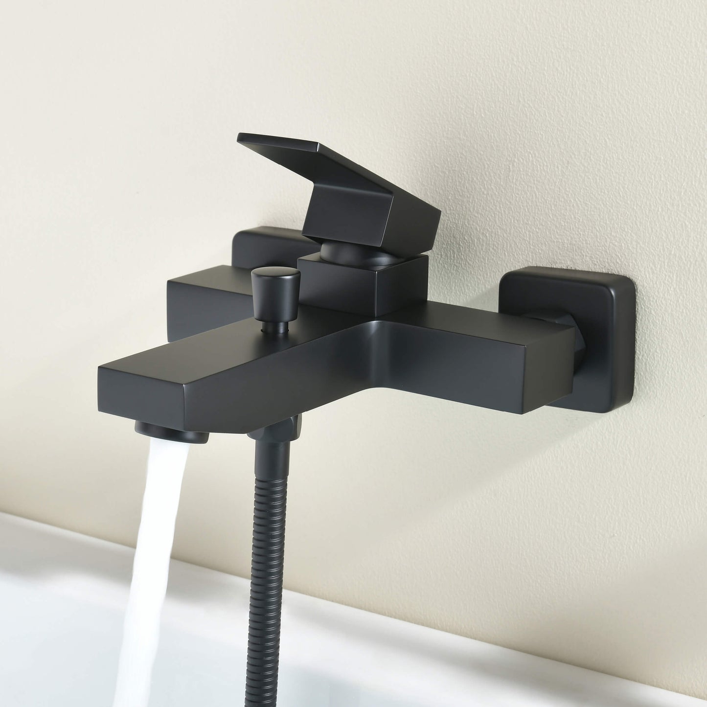 Matte black Cube bath shower mixer with bath spout in operation AT082202