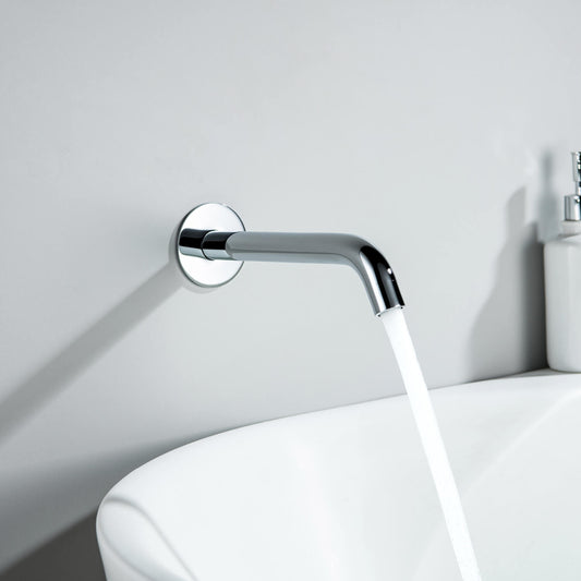 Aquavit Circular chrome wall-mounted bath spout installed above a modern bathtub