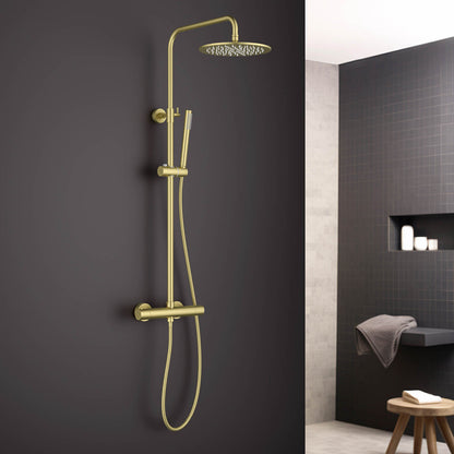 Aquavit AT097503 brushed gold thermostatic shower column in a luxury dark bathroom