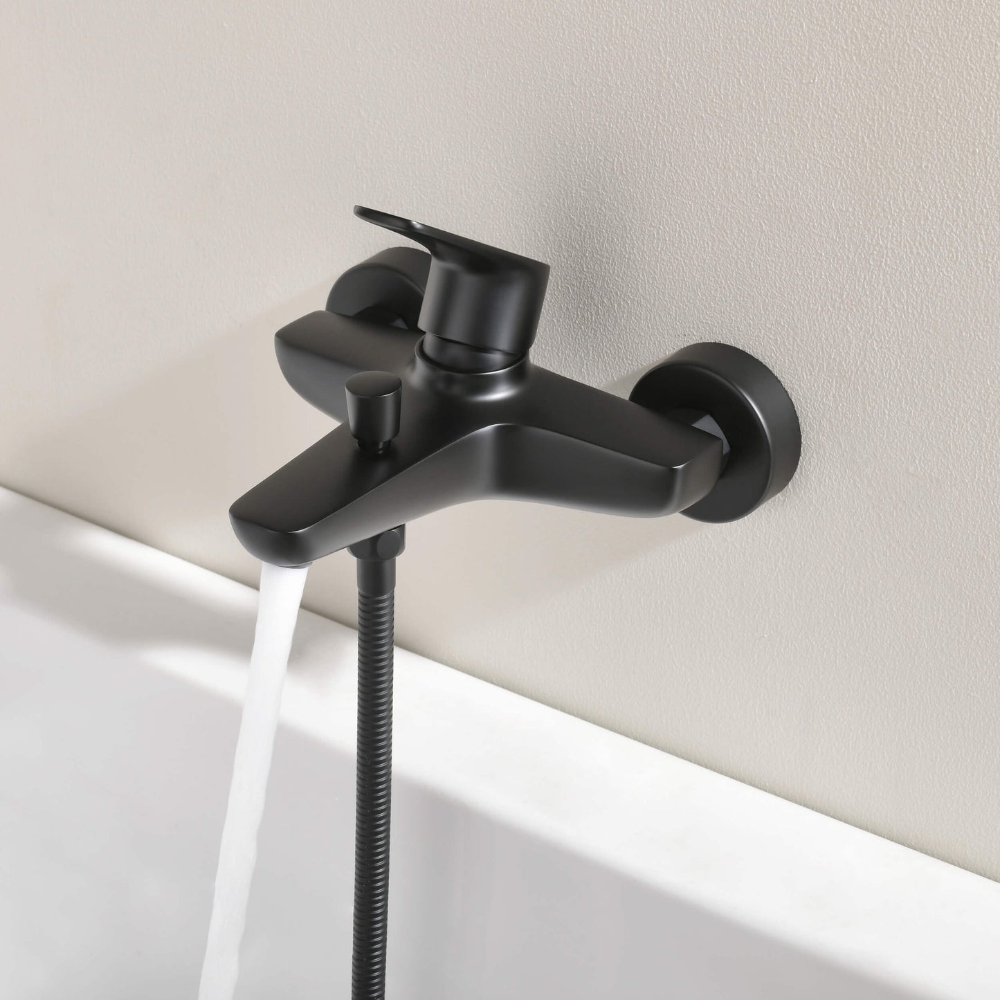 Aquavit Harmony matte black bath shower mixer installed above bathtub AT222200
