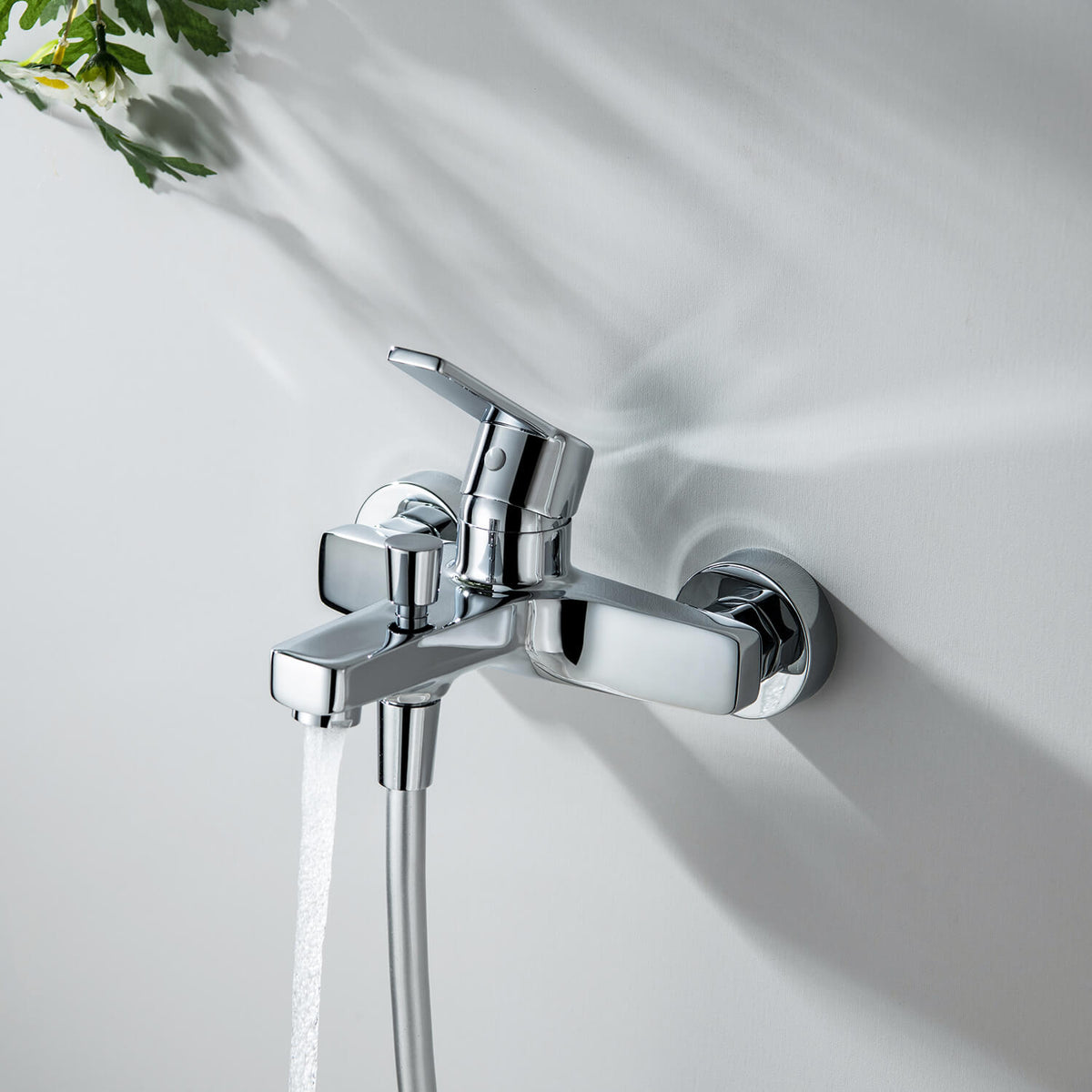Aquavit Sense chrome bath shower mixer with water flowing from the bath spout